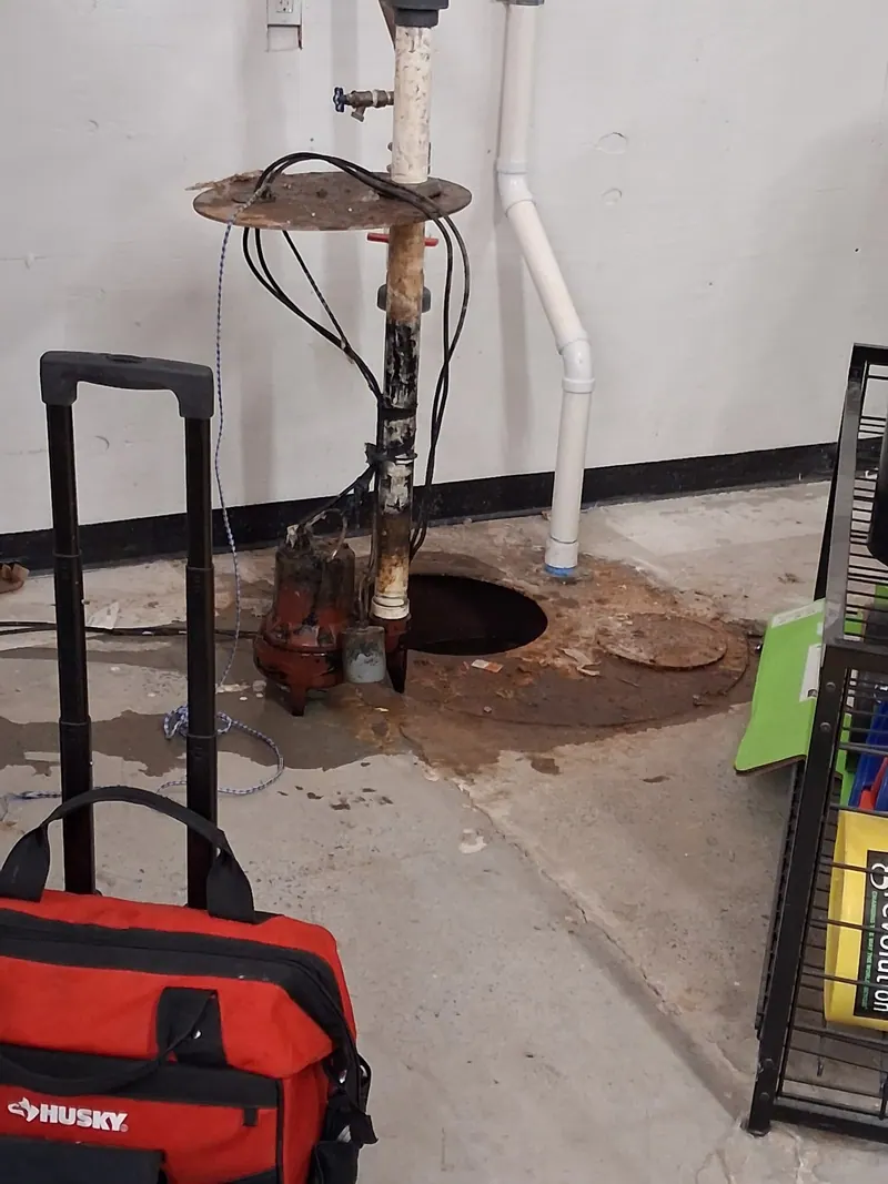 Basement sump pump pit opened by a Fullerton plumber for sump pump repair and replacement