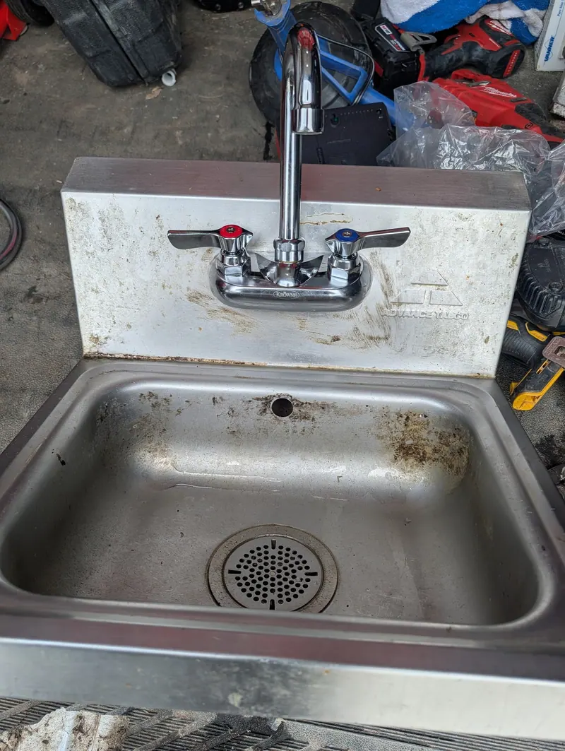 Stainless steel commercial hand sink with faucet repaired by Fullerton