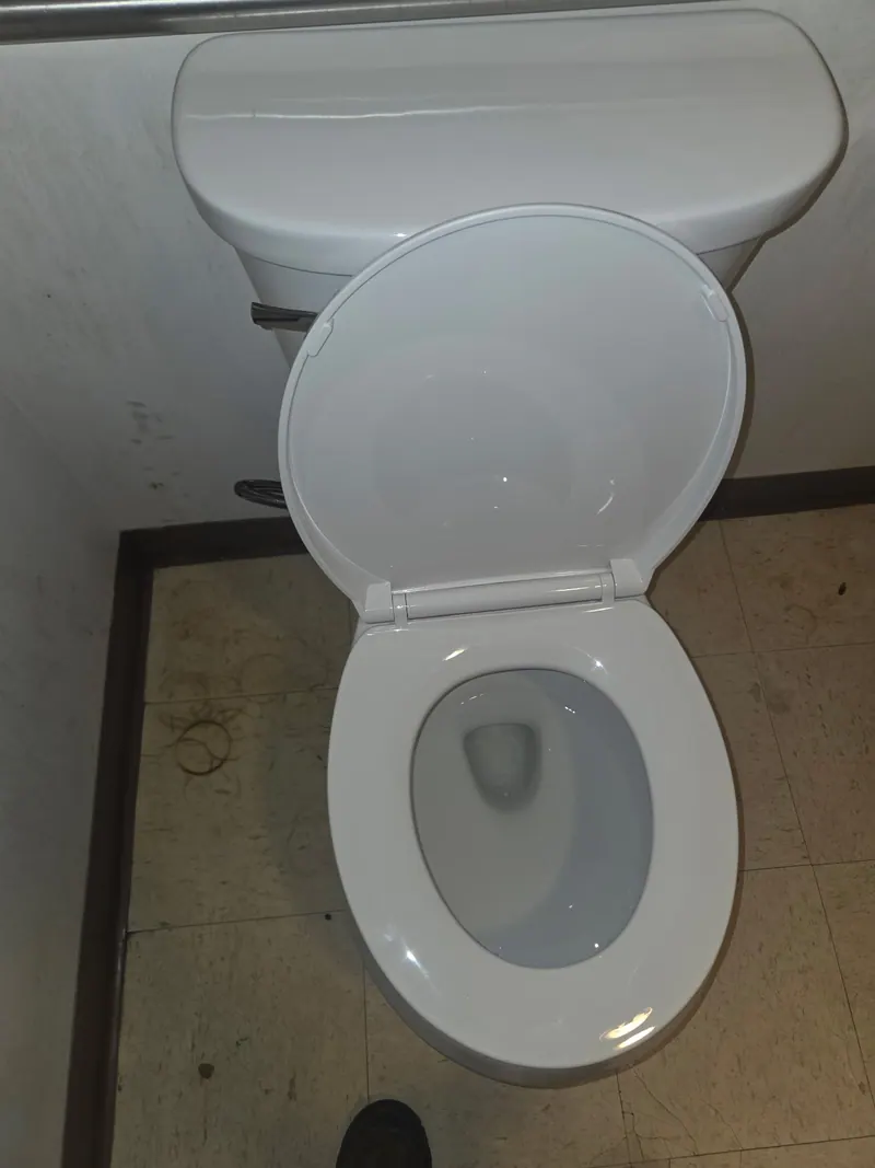 Newly installed white toilet in a commercial restroom after Fullerton toilet replacement