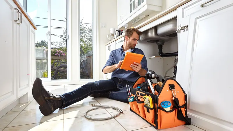 Fullerton plumber inspecting kitchen plumbing in a New York home
